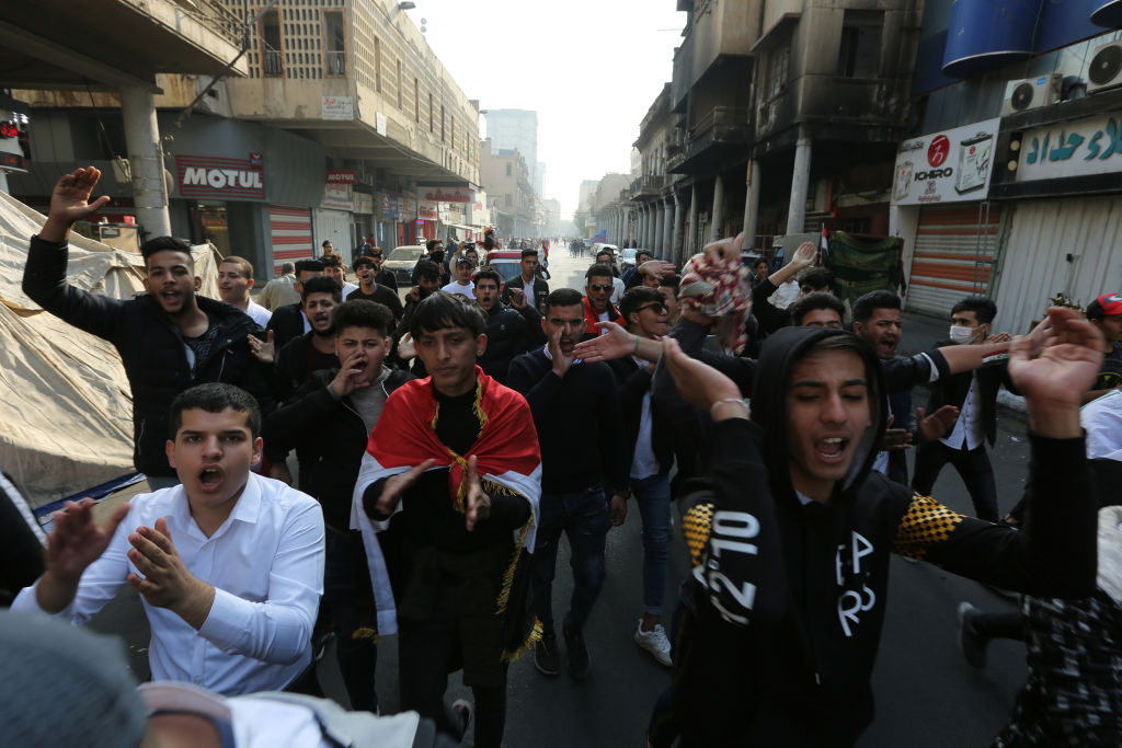 Iraqi protesters chant slogans during a demonstration in Baghdad's al-Rasheed street near al-Ahrar bridge on November 24, 2019. 