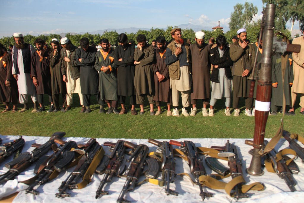 Member of the Islamic state ISIS militants stand alongside their weapons, as they surrendered to government in Jalalabad, Nangarhar, Afghanistan on November 17, 2019. 