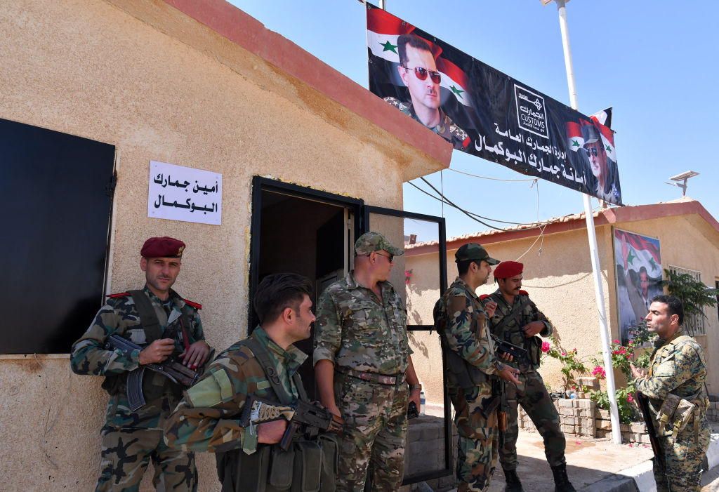 Members of the Syrian security forces gather at the border-crossing between Albu Kamal in Syria and Al-Qaim in Iraq, on the Syrian side in the eastern region of Deir Ezzor, on September 30, 2019. 