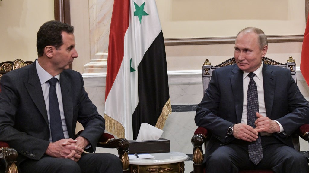 Syria's President Bashar al-Assad (L) and Russia's President Vladimir Putin during a meeting in the Cathedral of Our Lady of the Dormition. 