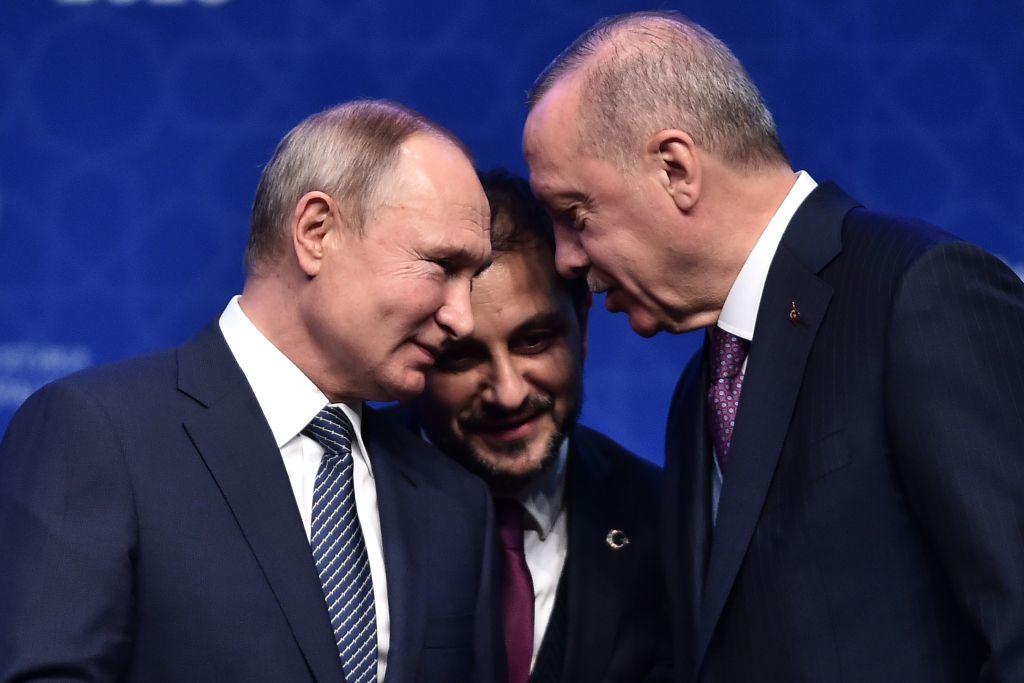 Russian President Vladimir Putin (L) and Turkish President Recep Tayyip Erdogan (R) speak as they attend an inauguration ceremony of a new gas pipeline 