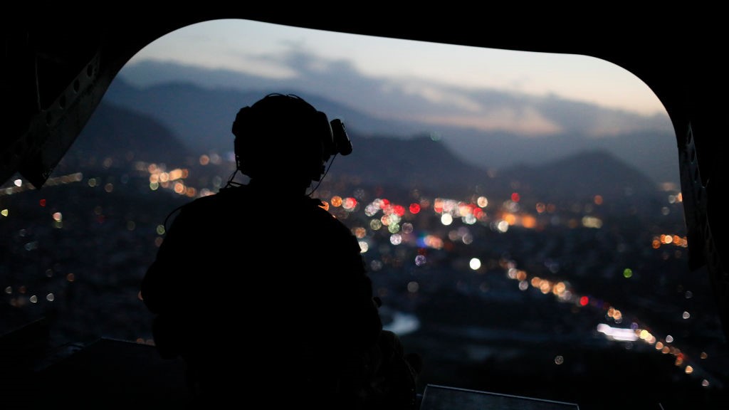 A US Army serviceman sits at the tailgate of an helicopter carrying US Defence Secretary, after leaving the Resolute Support headquarters, in the Afghan capital Kabul on April 24, 2017. 