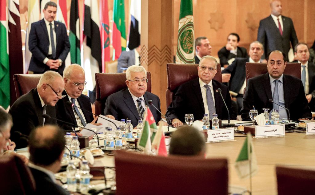 Palestinian president Mahmud Abbas (3rd-L) and Palestine Liberation Organisation (PLO) Secretary-General Saeb Erekat (2nd-L) look on as Arab League Secretary-General Ahmed Aboul Gheit (L) reads a statement during an Arab League emergency meeting discussing the US-brokered proposal for a settlement of the Middle East conflict, at the league headquarters in the Egyptian capital Cairo on February 1, 2020.