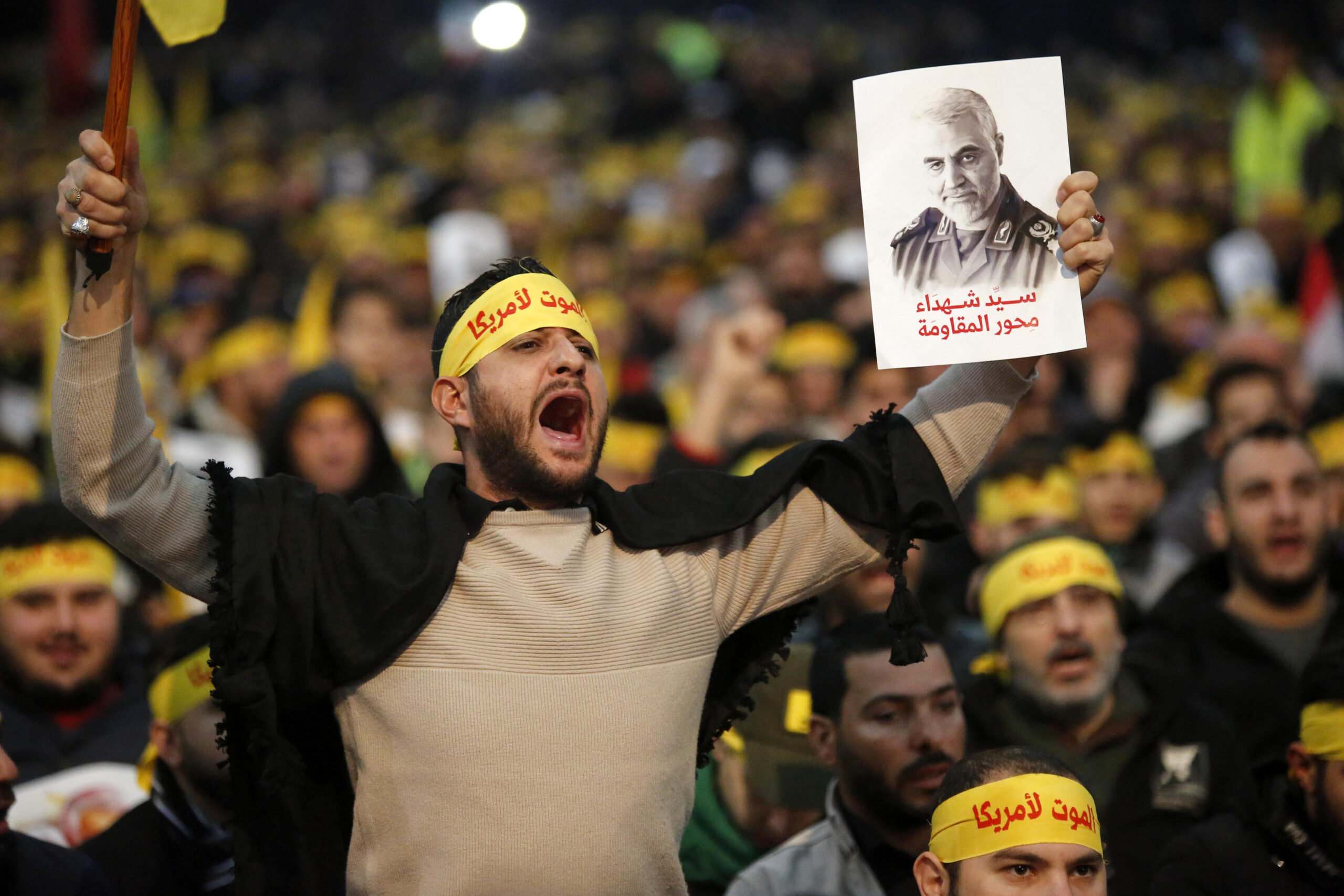 Supporters shout slogans during a rally for Qassem Soleimani in southern suburbs of Beirut, Lebanon, on Jan. 5, 2020. Hezbollah leader Sayyed Hassan Nasrallah urged on Sunday its fighters to attack U.S. soldiers in the region in retaliation for the assassination of Iranian top commander Qassem Soleimani by the United States. (Photo by Bilal Jawich/Xinhua via Getty) (Xinhua/ via Getty Images)