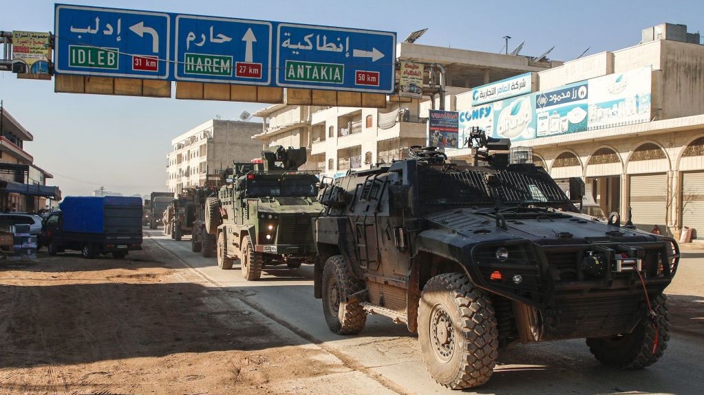 A Turkish military convoy of tanks and armoured vehicles passes through the Syrian town of Dana, east of the Turkish-Syrian border in the northwestern Syrian Idlib province, on February 2, 2020.