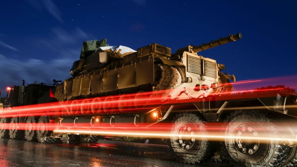  A Turkish military convoy of tanks and armoured vehicles passes through the city of Idlib, in northwestern Syria, near the Syria-Turkey border, late on February 7, 2020.