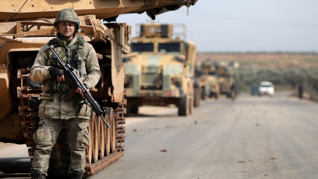 A Turkish soldier stands in front of a military vehicles convoy east of Idlib city in northwestern Syria on February 20, 2020 amid ongoing regime offensive on the last major rebel bastion in the country's northwest. 
