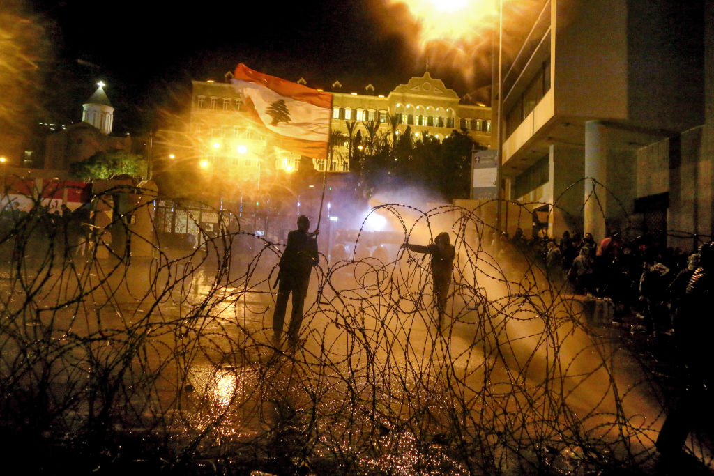 Riot policemen use water cannons to disperse anti-government protesters during clashes near the Grand Serail, headquarters of the Prime Minister of Lebanon. Photo: Marwan Naamani/dpa (Photo by Marwan Naamani/picture alliance via Getty Images)