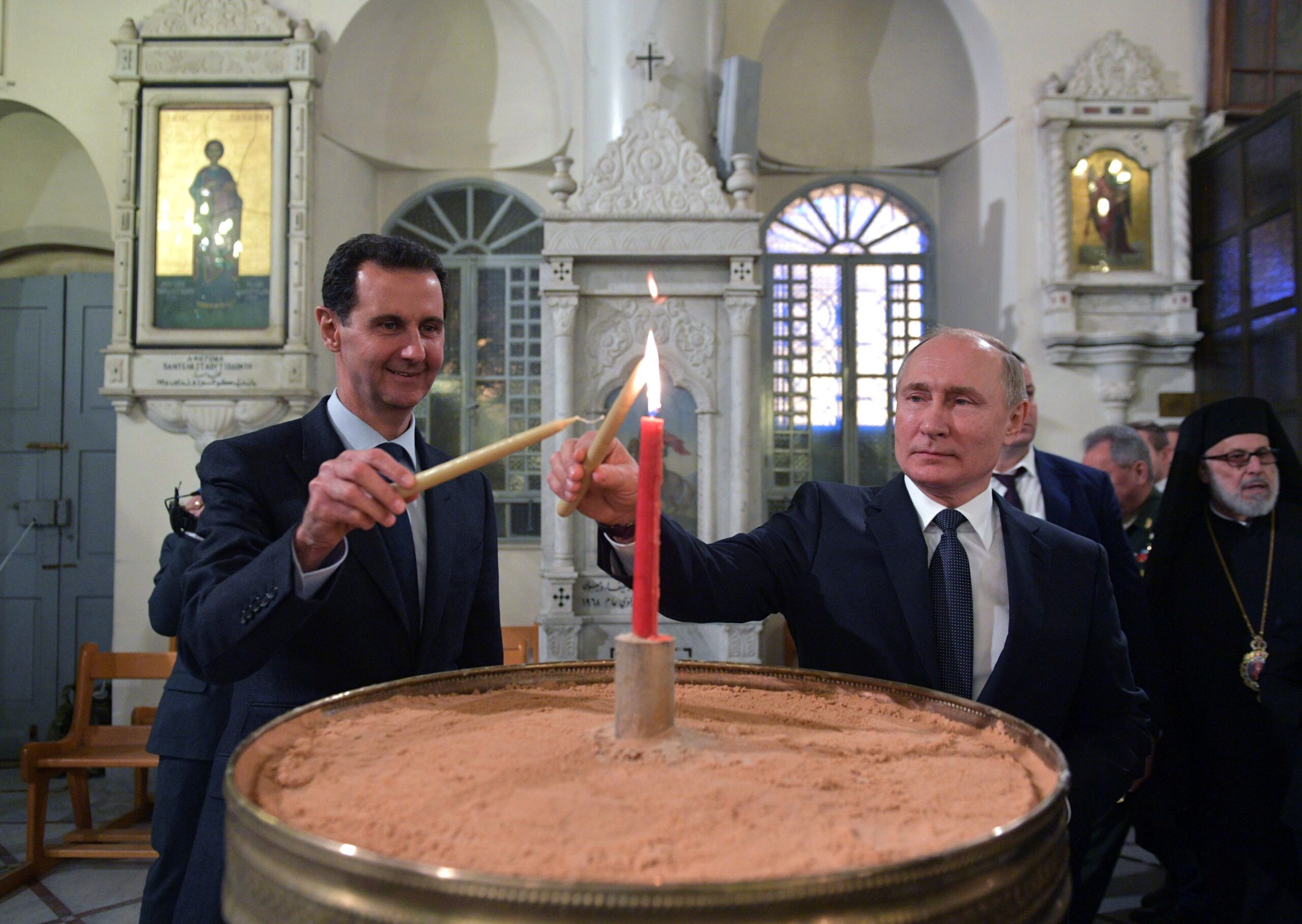 Russian President Vladimir Putin and Syrian President Bashar al-Assad visit the Mariamite Cathedral of Damascus, one of the oldest Greek Orthodox churches in the Syrian capital, in Damascus on January 7, 2020. - Putin met his Syrian counterpart Bashar al-Assad during an unprecedented visit to Damascus as the prospect of war between Iran and the United States loomed over the region. (Photo by Alexey DRUZHININ / SPUTNIK / AFP) (Photo by ALEXEY DRUZHININ/SPUTNIK/AFP via Getty Images)