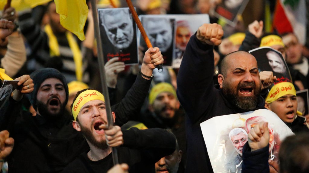 Supporters shout slogans during a rally for Qassem Soleimani in southern suburbs of Beirut, Lebanon, on Jan. 5, 2020. Hezbollah leader Sayyed Hassan Nasrallah urged on Sunday its fighters to attack U.S. soldiers in the region in retaliation for the assassination of Iranian top commander Qassem Soleimani by the United States. (Photo by Bilal Jawich/Xinhua via Getty) (Xinhua/ via Getty Images)