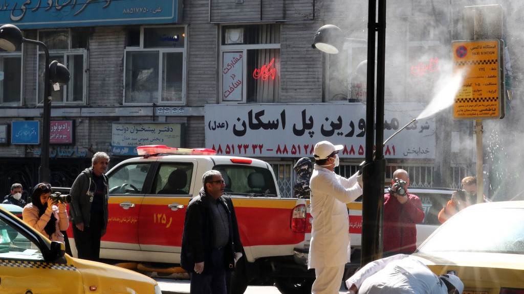 Iranian fire fighters and municipality workers disinfect a street in the capital Tehran for corona virus COVID-19 on March 5, 2020. 