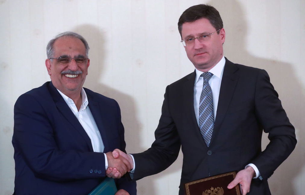 Iran's Minister of Economic Affairs and Finance, Masoud Karbasian (L) and Russias Energy Minister Alexander Novak shake hands at a signing ceremony following a meeting of the Russian-Iranian intergovernmental commission for trade and economic cooperation at Moscow's President Hotel