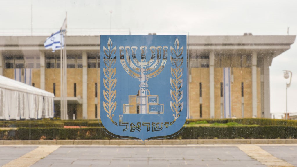 An emblem of Israel with the Knesset in the background, seen on the day of Israeli Legislative Elections 2020, in Central Jerusalem.