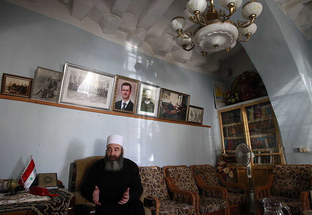 Sheikh Hikmat Hajari, a top Druze cleric, sits in his home in the southern city of Sweida on January 23, 2013. Abductions of Druze officials in Daraa were rampant in May and June of last year, prompting the inhabitants of Sweida to respond in kind, leaving behind a palpable distrust between the provinces, though Sweida hosts some 9,000 displaced people of Daraa. AFP PHOTO/ANWAR AMRO (Photo credit should read ANWAR AMRO/AFP via Getty Images)