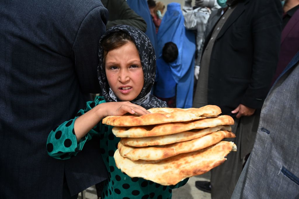 Young Afghan girl holding bread. 