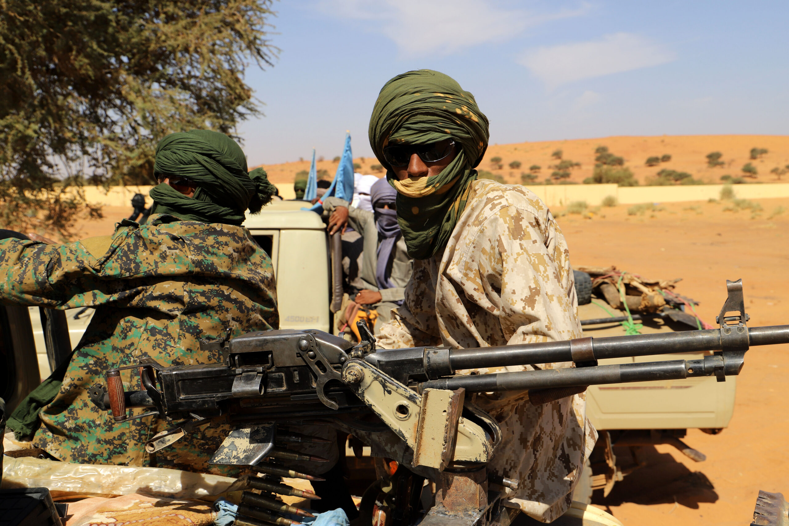 Photo above: Fighters from local armed group Gatia and pro-government armed group National Movement for the Liberation of Azawad (MNLA) patrol around the Malian town of Menaka on Nov. 21, 2020. Photo by SOULEYMANE AG ANARA/AFP via Getty Images.
