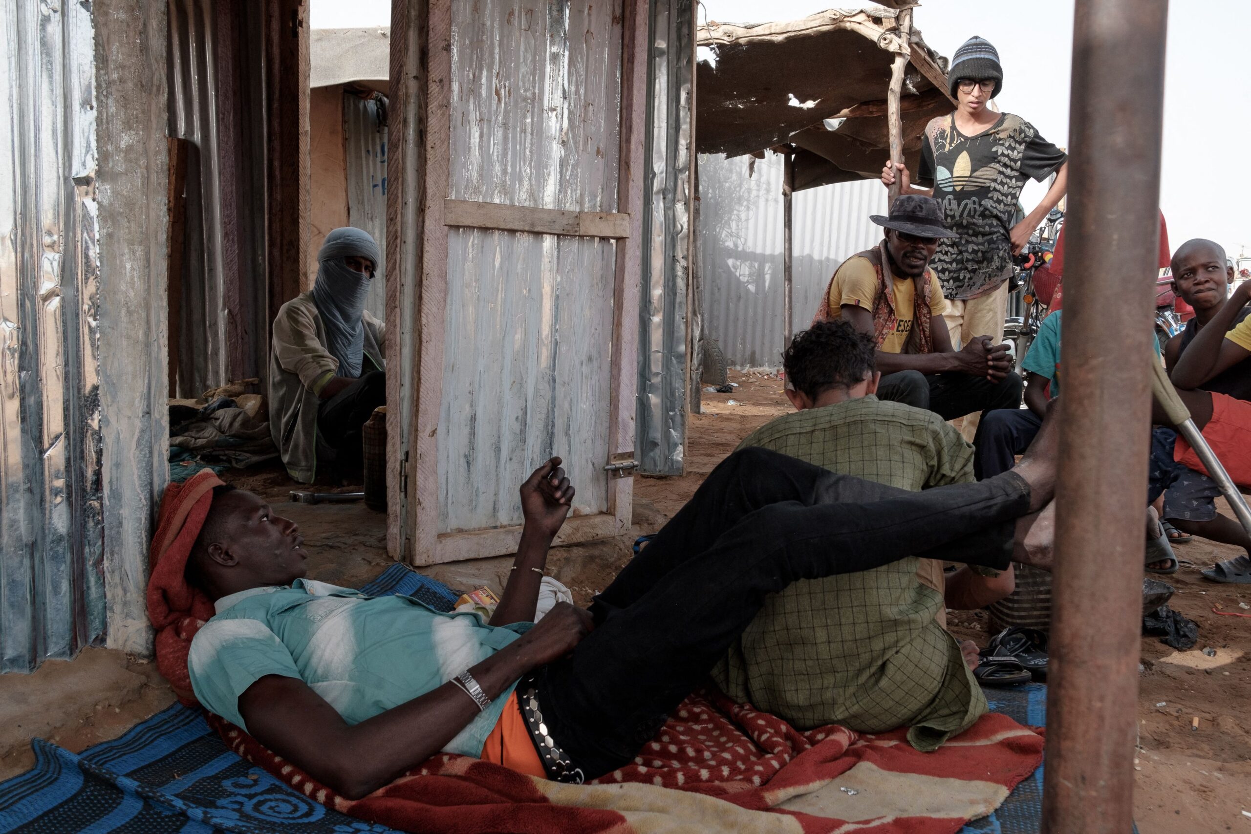 Photo above: People rest in the shade at the M’Berra refugee camp in Bassikonou, Muaritania, on June 8, 2022. Photo by GUY PETERSON/AFP via Getty Images.