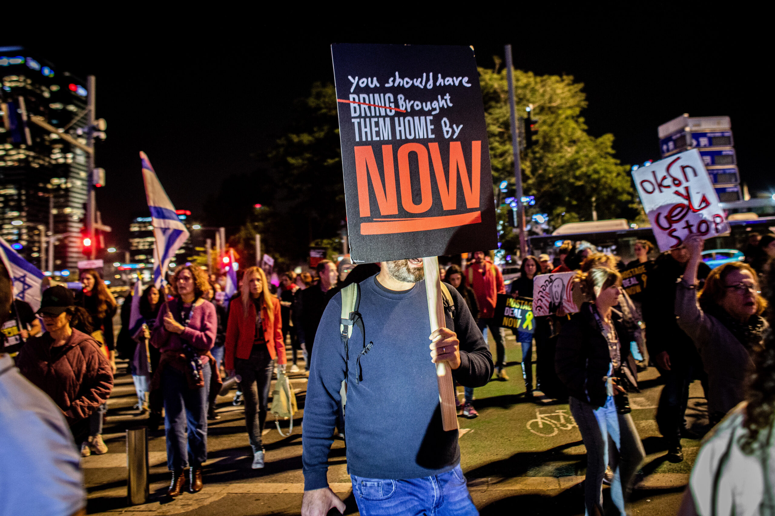 Photo above: A man holds up a placard during a protest, on March 26, 2024, urging the government to secure a hostage release deal with Hamas. Photo by Eyal Warshavsky/SOPA Images/LightRocket via Getty Images.