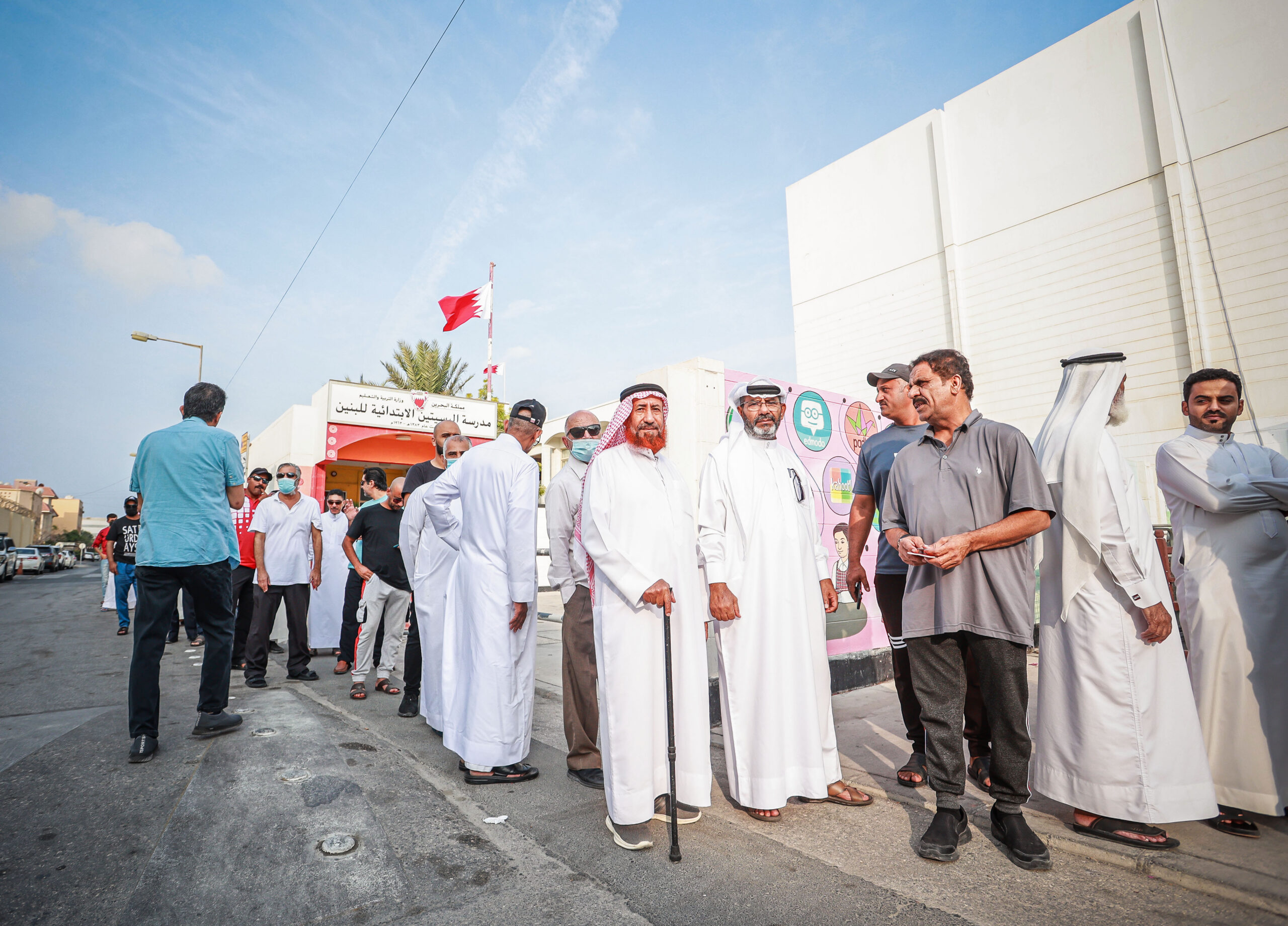 Bahraini people wait in line to cast their ballots in front of the polling station during the second round of parliamentary and municipal elections in Muharraq on Nov. 19, 2022. Photo by Ayman Yaqoob/Anadolu Agency via Getty Images.