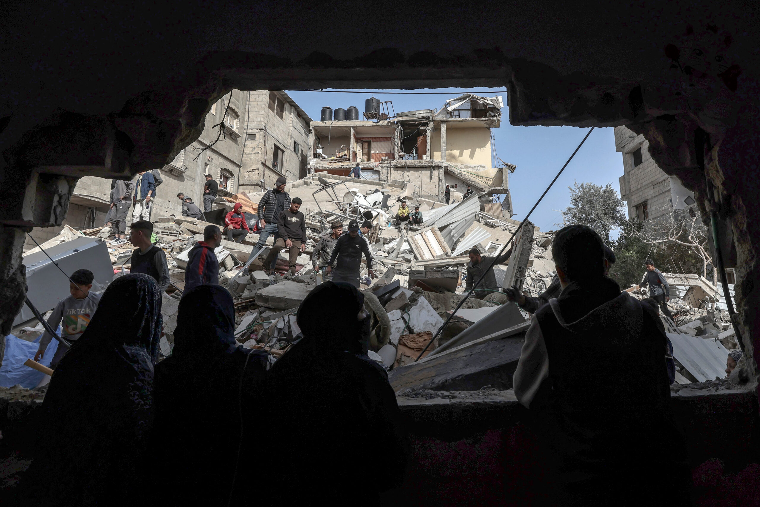 Photo above: Palestinians check the rubble of buildings that were destroyed following an overnight Israeli bombardment in Rafah, in the southern Gaza Strip, last spring. Photo by MOHAMMED ABED/AFP via Getty Images.