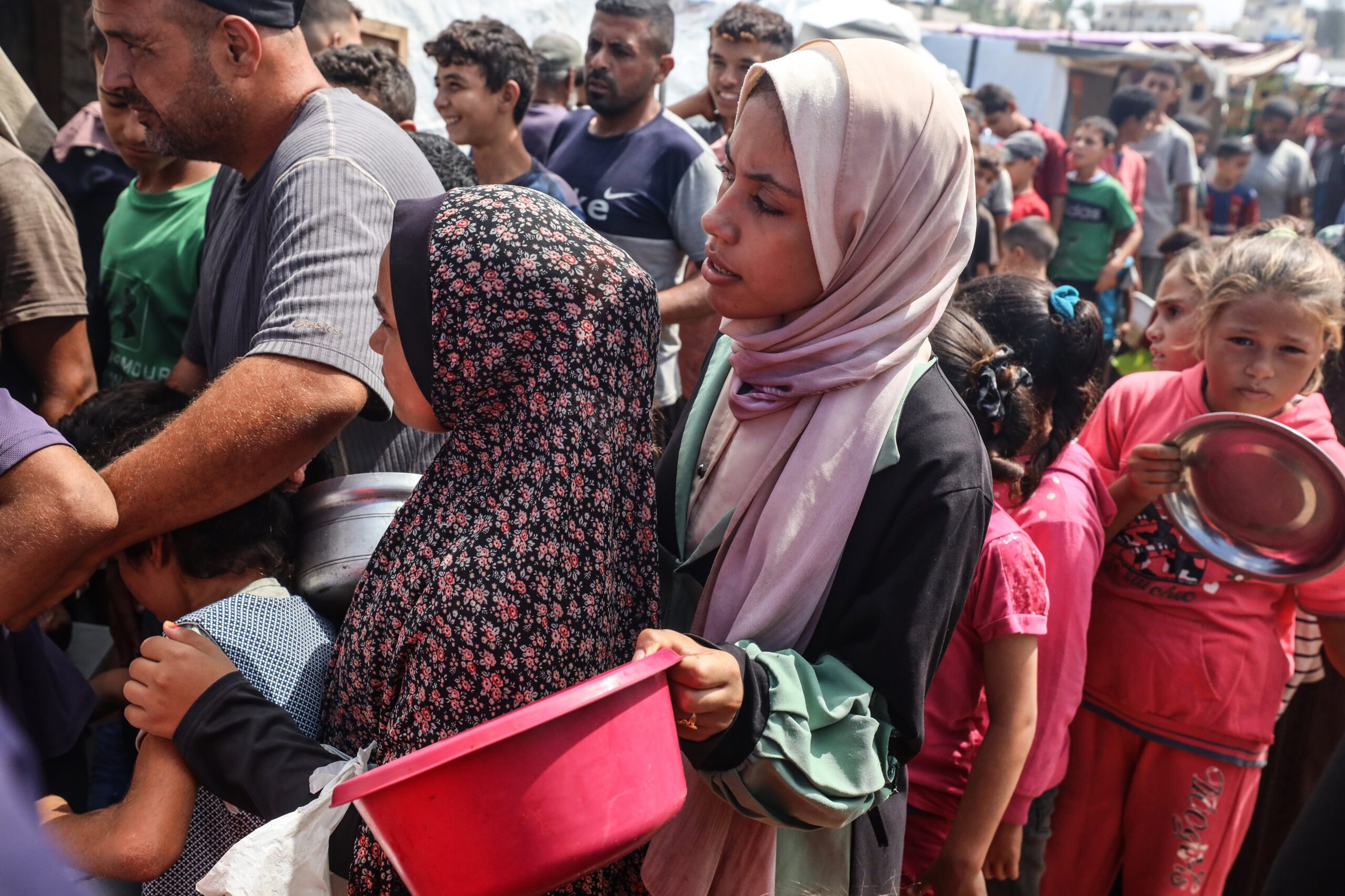 Photo above: Palestinians receive cooked food rations as part of a volunteer initiative in a makeshift displacement camp in Deir al-Balah, Gaza Strip, on Sept. 23, 2024, amid the ongoing war between Israel and Hamas. Photo by Majdi Fathi/NurPhoto via Getty Images.