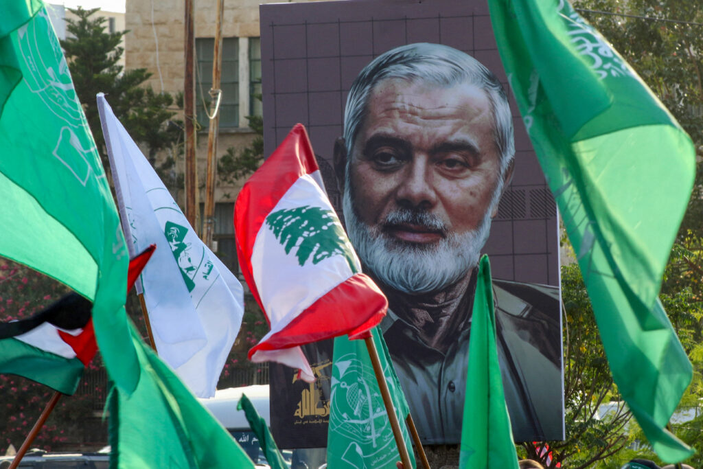 A portrait of slain Hamas leader Ismail Haniyeh is displayed during a demonstration denouncing his killing held in theLebanese coastal city of Sidon on Aug. 2, 2024. Photo by Mahmoud Zayyat/AFP via Getty Images.