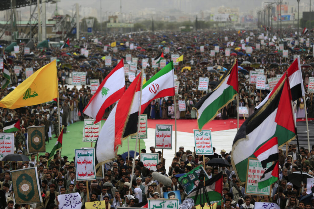 Yemenis wave the flags of Hizballah, Lebanon, Iran, Palestine, and Yemen during a rally in solidarity with Palestinians in the Gaza Strip in Sana’a on July 4, 2025. Source: Mohammed Huawis/AFP via Getty Images.