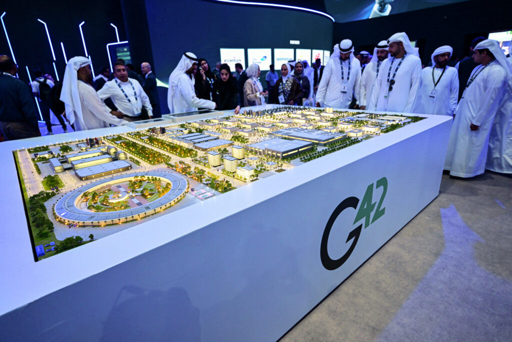 Photo above: Guests look at a model of a data center under construction in the UAE as part of the Stargate initiative, a joint venture between G42, Microsoft, and OpenAI, during the Abu Dhabi International Petroleum Exhibition & Conference (ADIPEC) in Abu Dhabi on November 3, 2025. Photo by Giuseppe Cacace/AFP via Getty Images.
