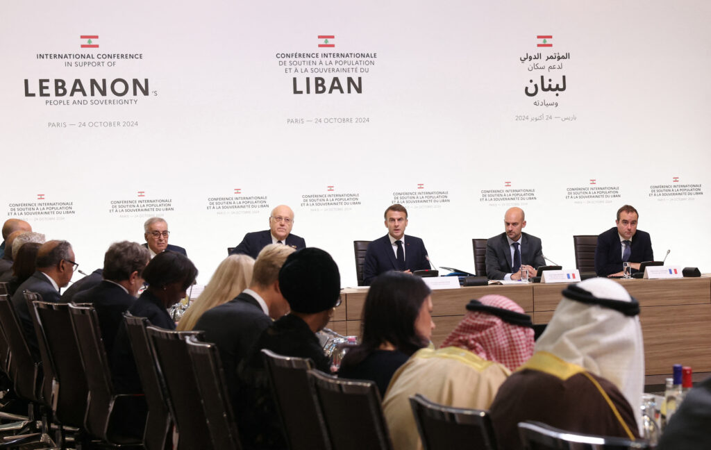 French President Emmanuel Macron speaks next to Lebanon’s then-prime minister, Najib Mikati, during an international conference in support ofLebanon in Paris on October 24, 2024. Photo by ALAIN JOCARD/POOL/AFP via Getty Images.