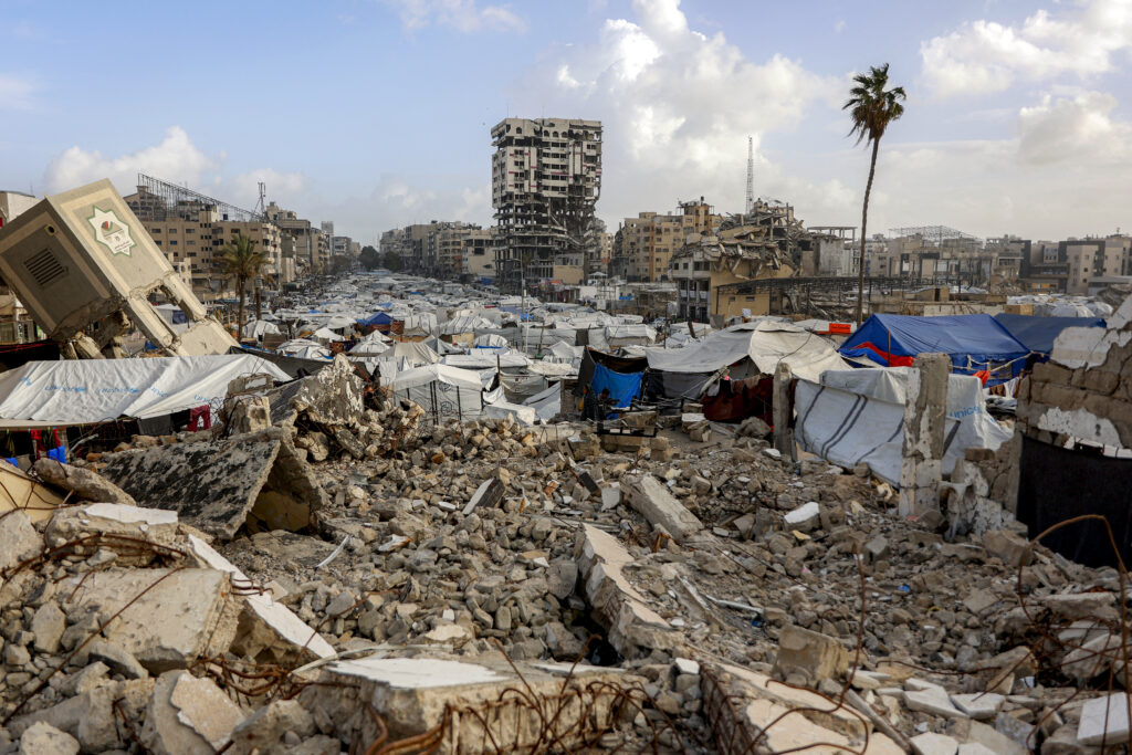 Tents and shelters are pictured at a camp for people displaced by conflict amid the rubble of the former headquarters of thePalestinian Legislative Council (PLC) in Gaza City on January 28, 2026. Source: Omar Al-Qattaa/AFP via Getty Images.