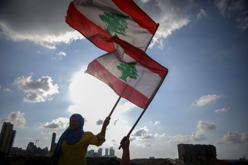 Lebanese women wave the national flag. Photo by PATRICK BAZ/AFP via Getty Images