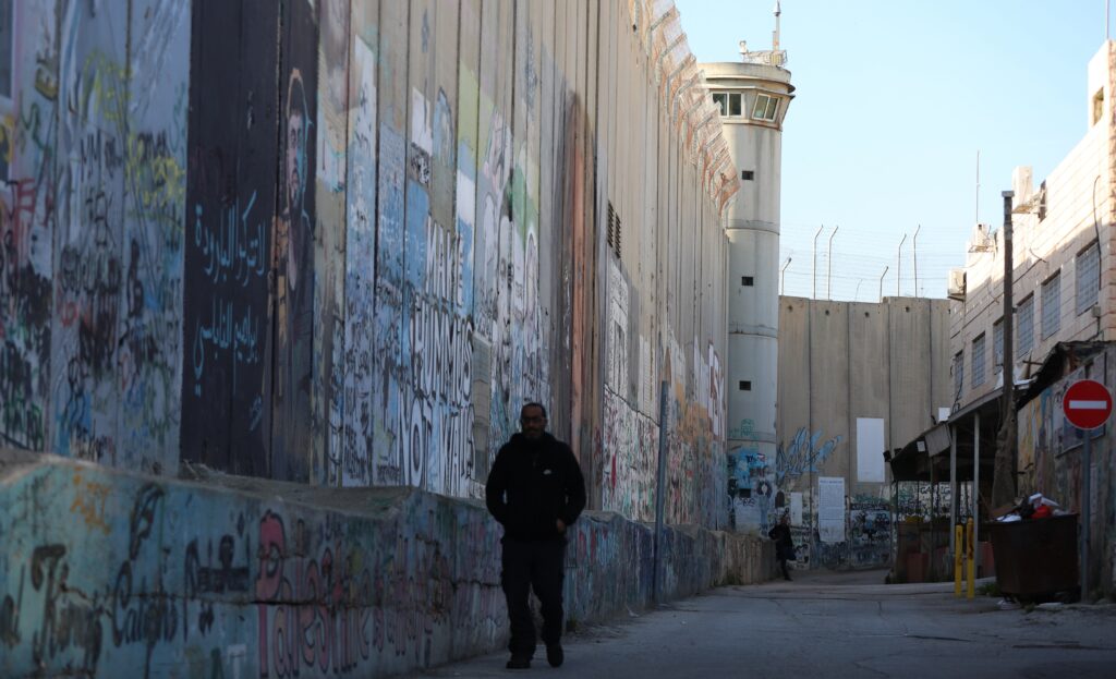 Photo above: Graffiti on the Israeli barrier wall between Jerusalem and Bethlehem in the West Bank, on March 31, 2026. Source: Wisham Hashlamoun/Anadolu via Getty Images.